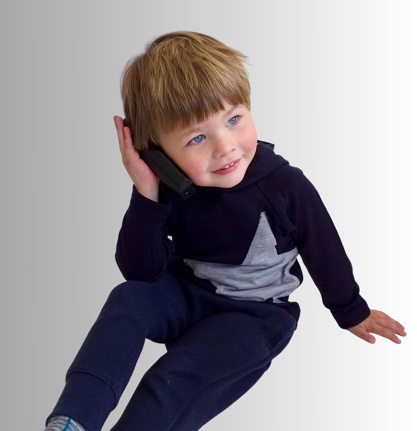 Front view of boy wearing navy star hoody