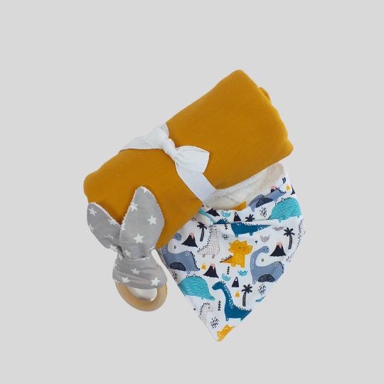 Rolled view of the Marigold Merino Baby Wrap along with a Bandana Dribble Bib and Teething Ring