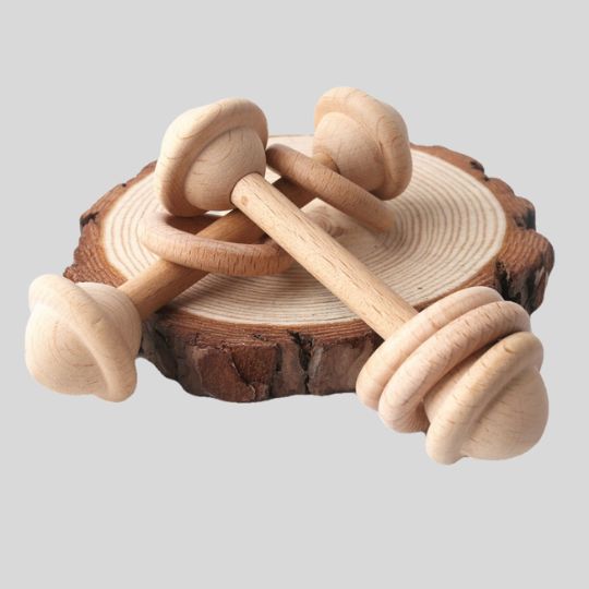 Two Wooden Rattles lying on a timber ring