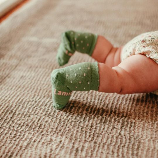 Baby lying on its tummy wearing Juniper Socks